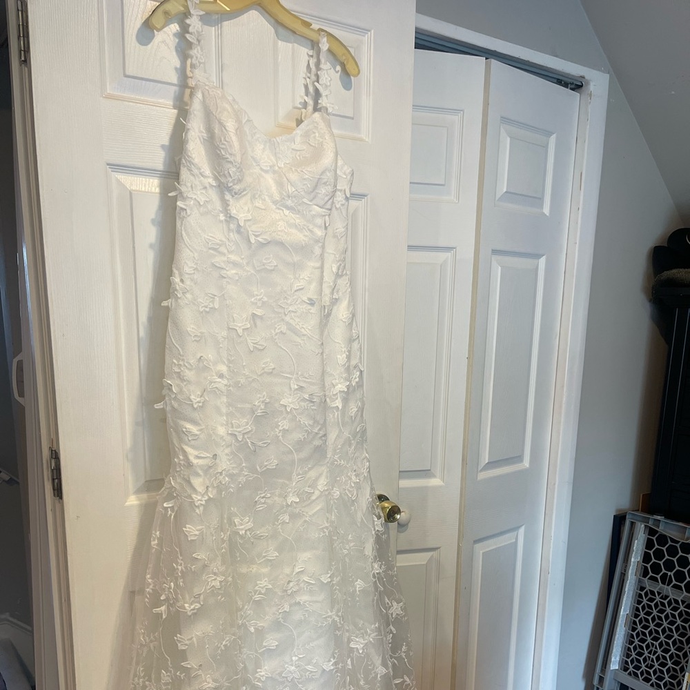 Brand new never worn.. White 3D flower embellishments covering the dress